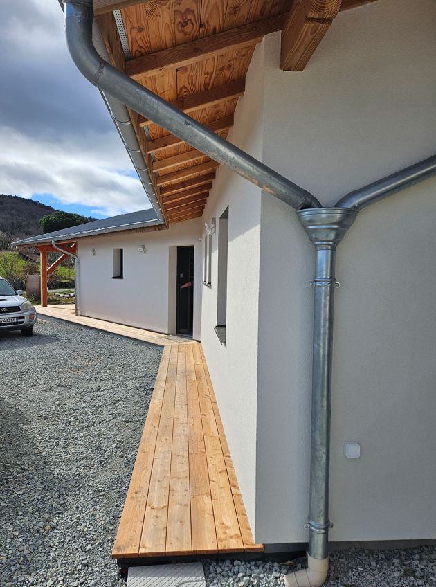 Descente de zinc sur une maison à ossature bois